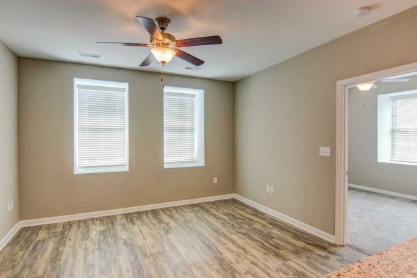 Apartment bedroom with wood-style plank flooring